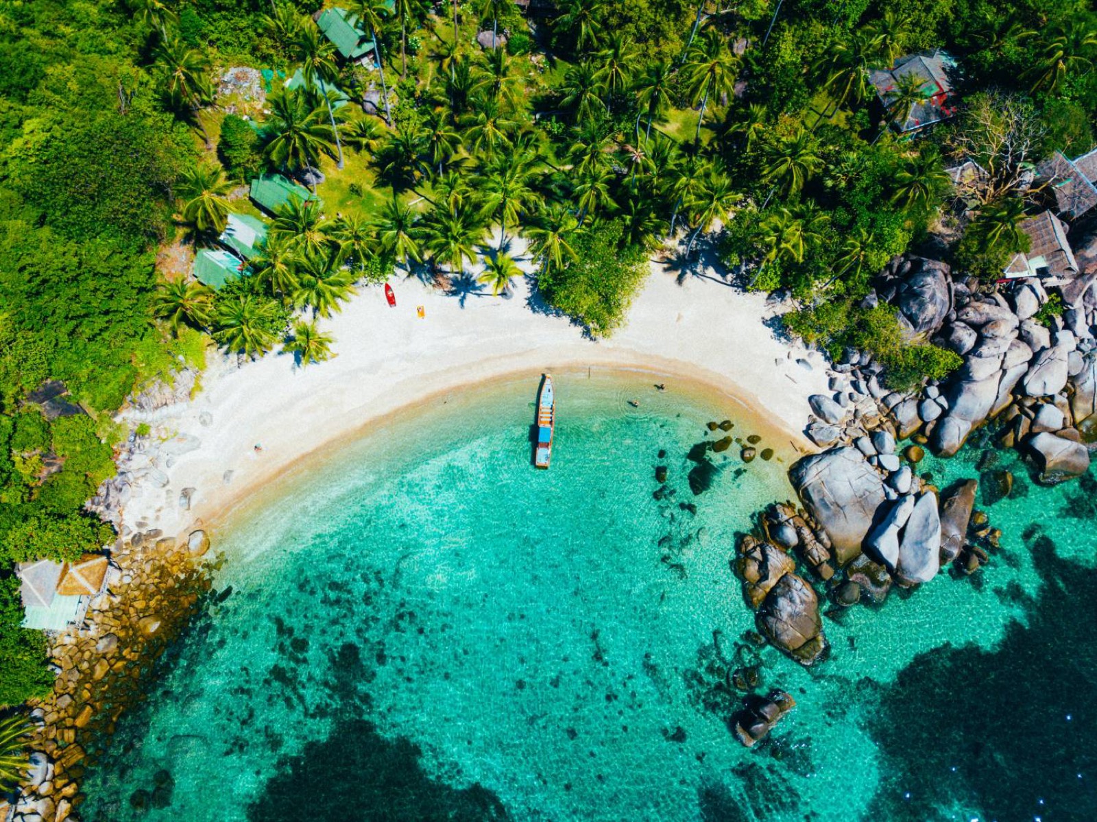 Aerial view of a Koh Tao beach with a longtail boat